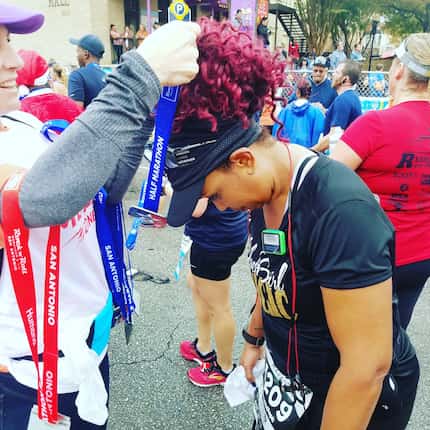 Daphne Jackson, who says running has brought her closer to God, bows her head to receive a...