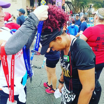 Daphne Jackson, who says running has brought her closer to God, bows her head to receive a...