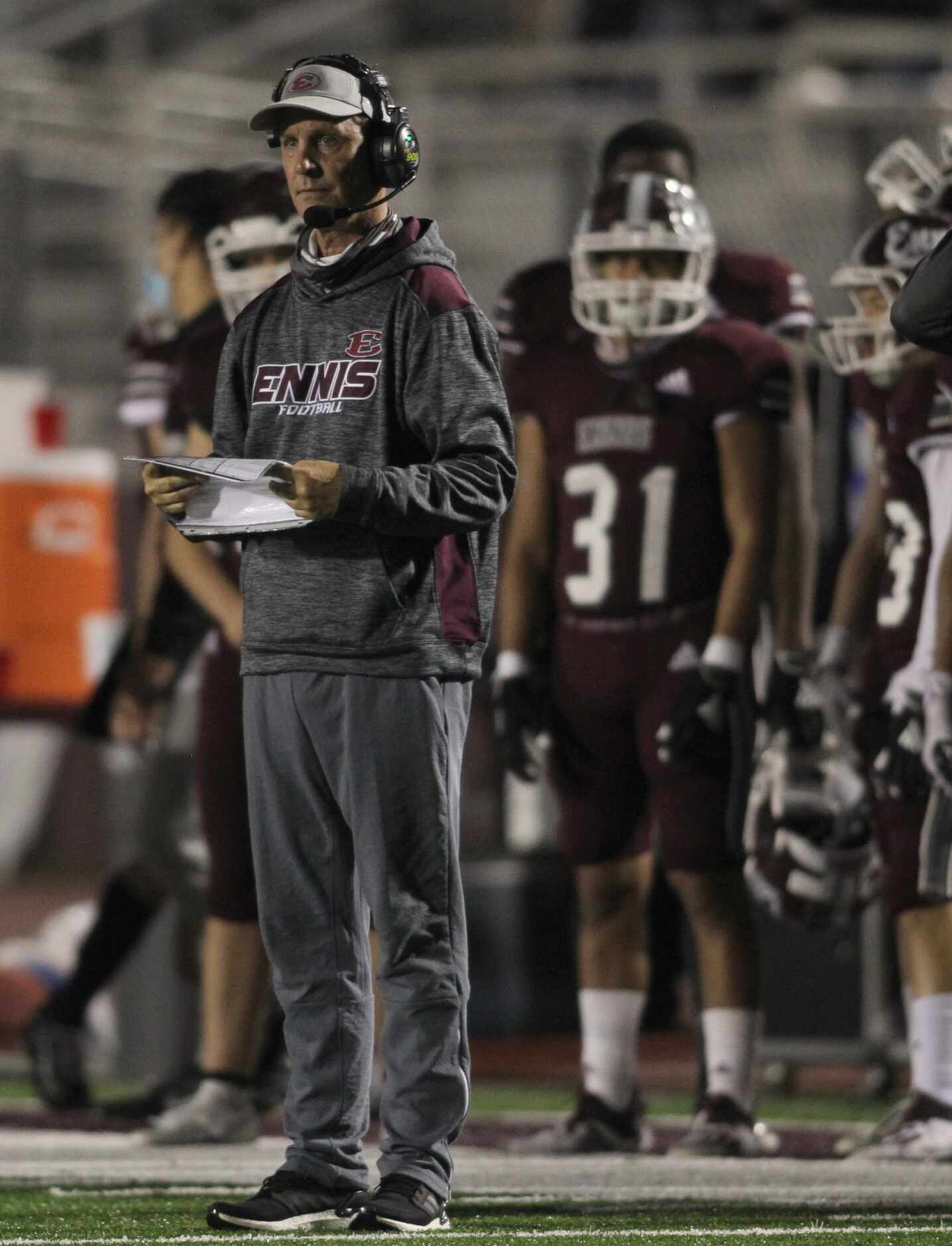 Ennis head coach Sam Harrell looks on from the team bench area during first half action...