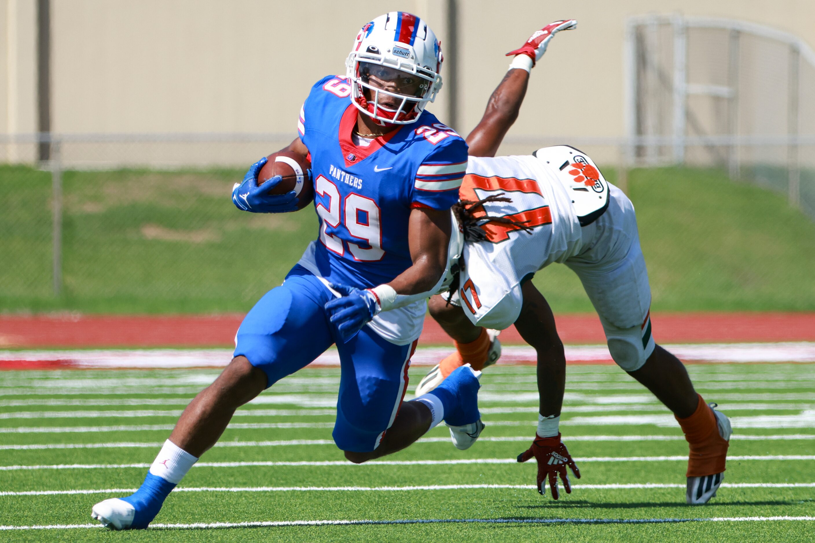 Duncanville High School Caden Durham (29) avoids Jones High School Adrian Jackson (17) while...