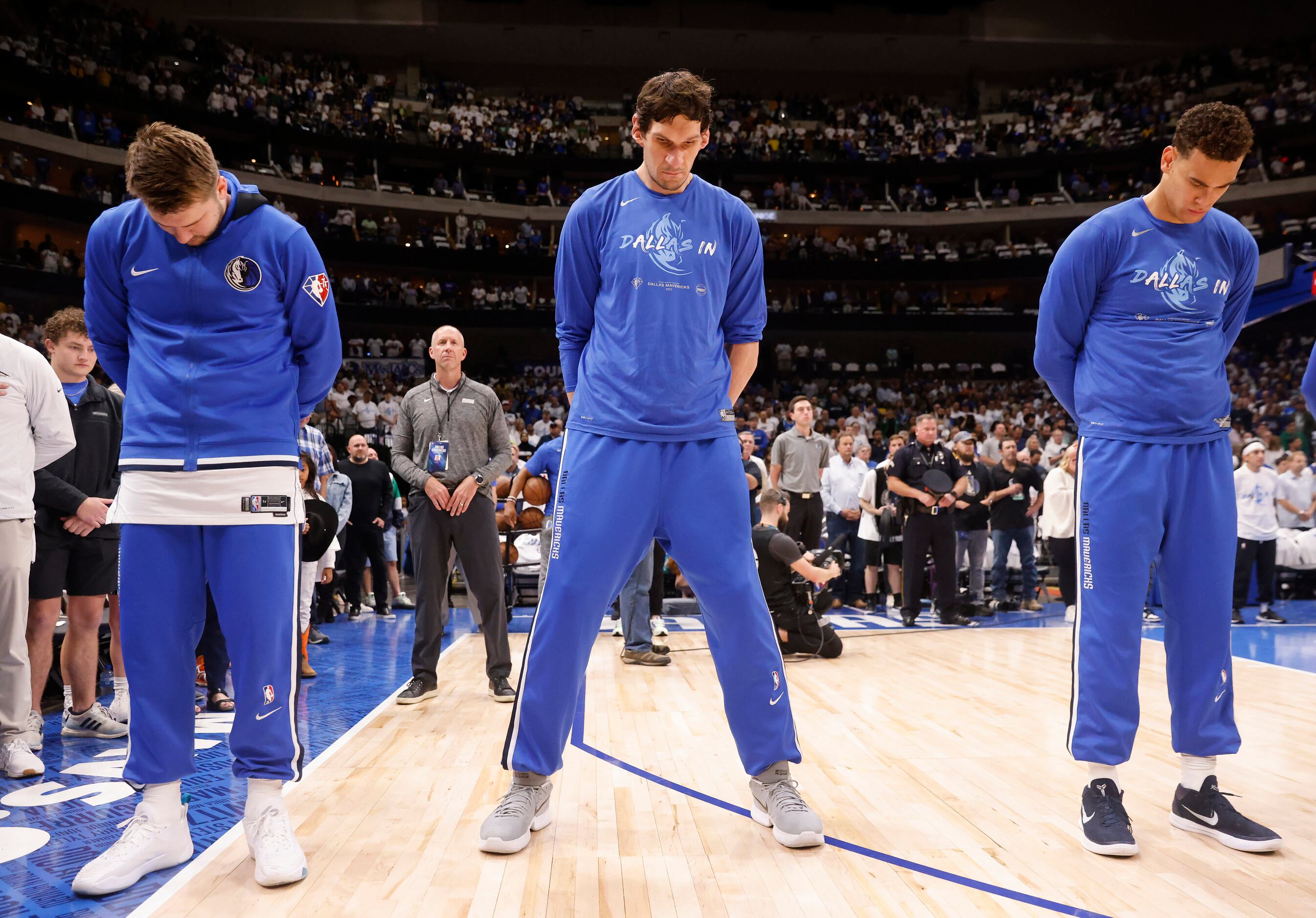 Dallas Mavericks Luka Doncic (left), Boban Marjanovic (center) and Dwight Powell bow their...