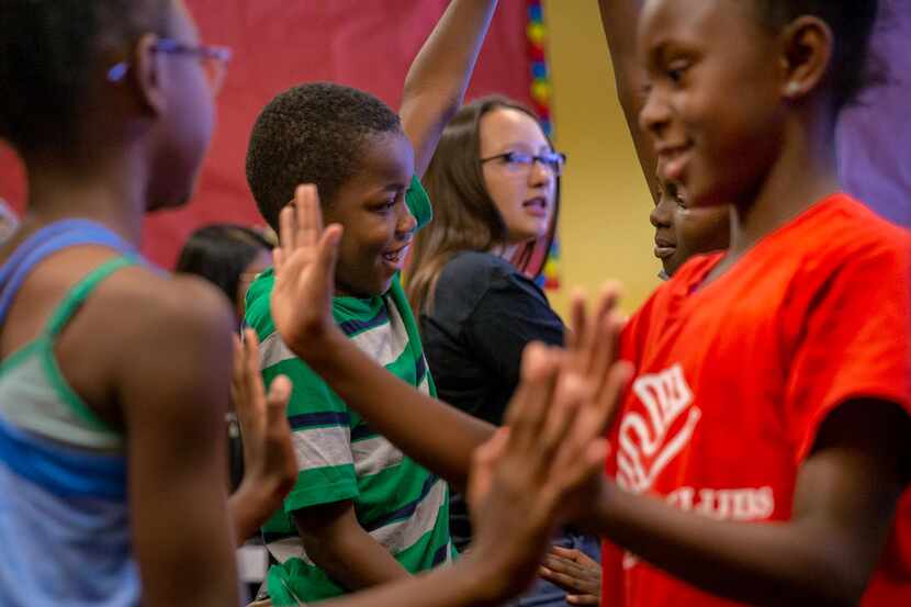 Theodore Penn, 10 (center) and Aaliyah Wills, 9 (right), participate in a pantomime exercise...