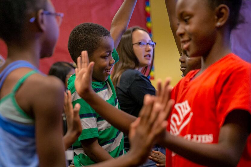 Theodore Penn, 10 (center) and Aaliyah Wills, 9 (right), participate in a pantomime exercise...