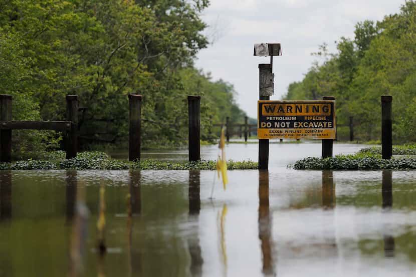 A sign and barrier for an existing pipeline is displayed on Bayou Sorrel in the Atchafalaya...