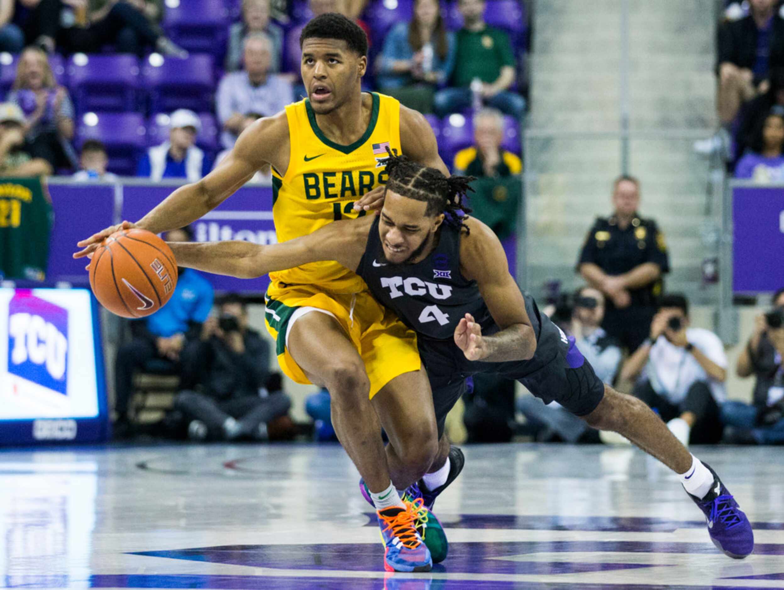 TCU Horned Frogs guard PJ Fuller (4) tries to take control of a loose ball from Baylor Bears...