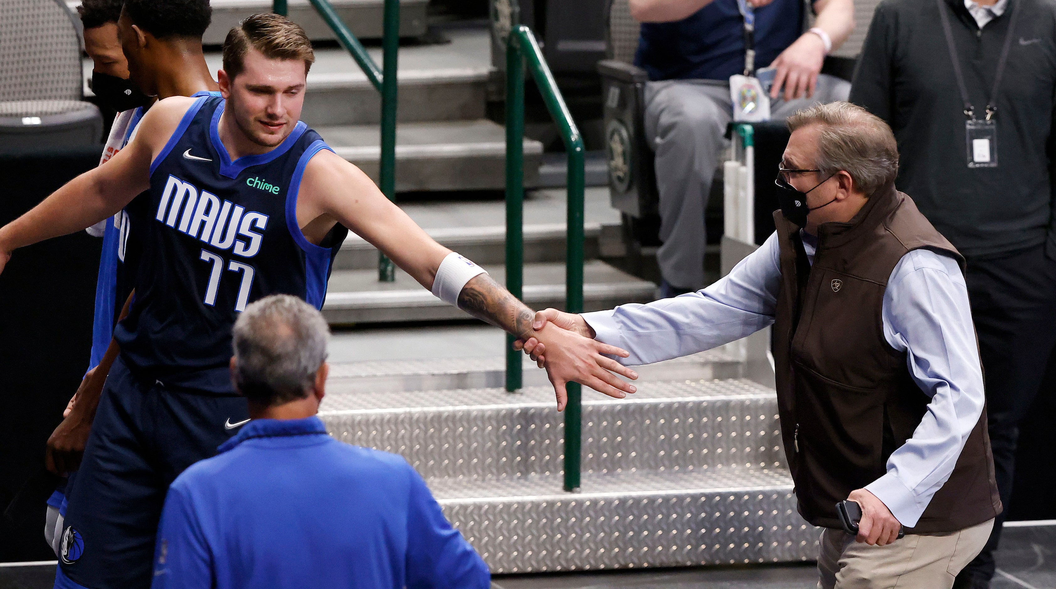 Dallas Mavericks guard Luka Doncic (77) reaches back for General Manager Donnie Nelson as...