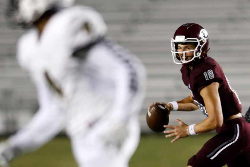 Ennis quarterback Collin Drake (18) rolls out in search of an open receiver during first...
