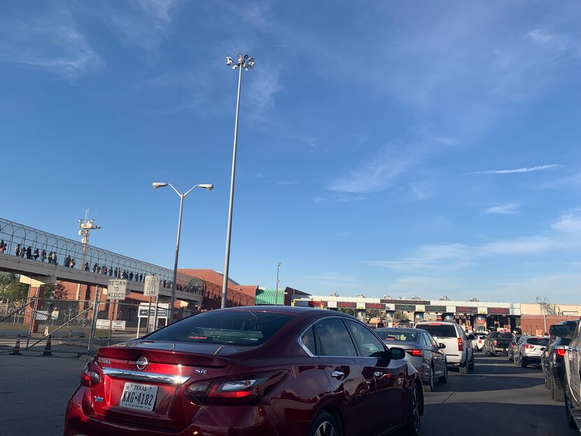 Lines of pedestrians and cars wait to cross to the U.S. from Mexico at the Zaragoza Bridge...