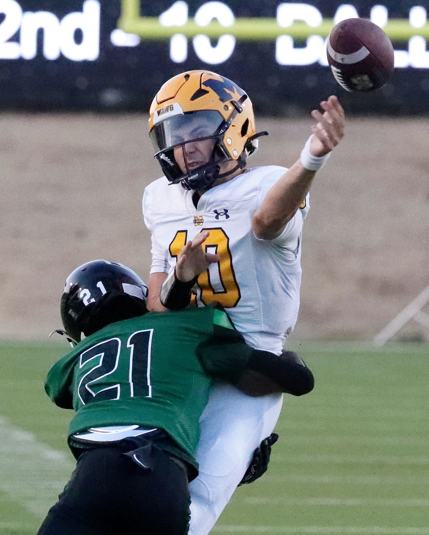 Berkner High School defensive back Rashad Harris (21) puts a hit on McKinney High School...