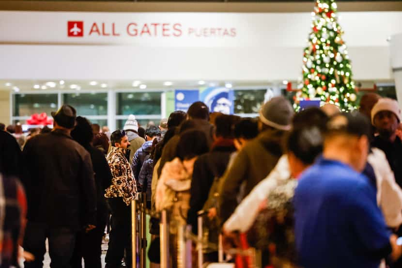 Travelers wait in line to be served by Southwest customer service staff after most flights...