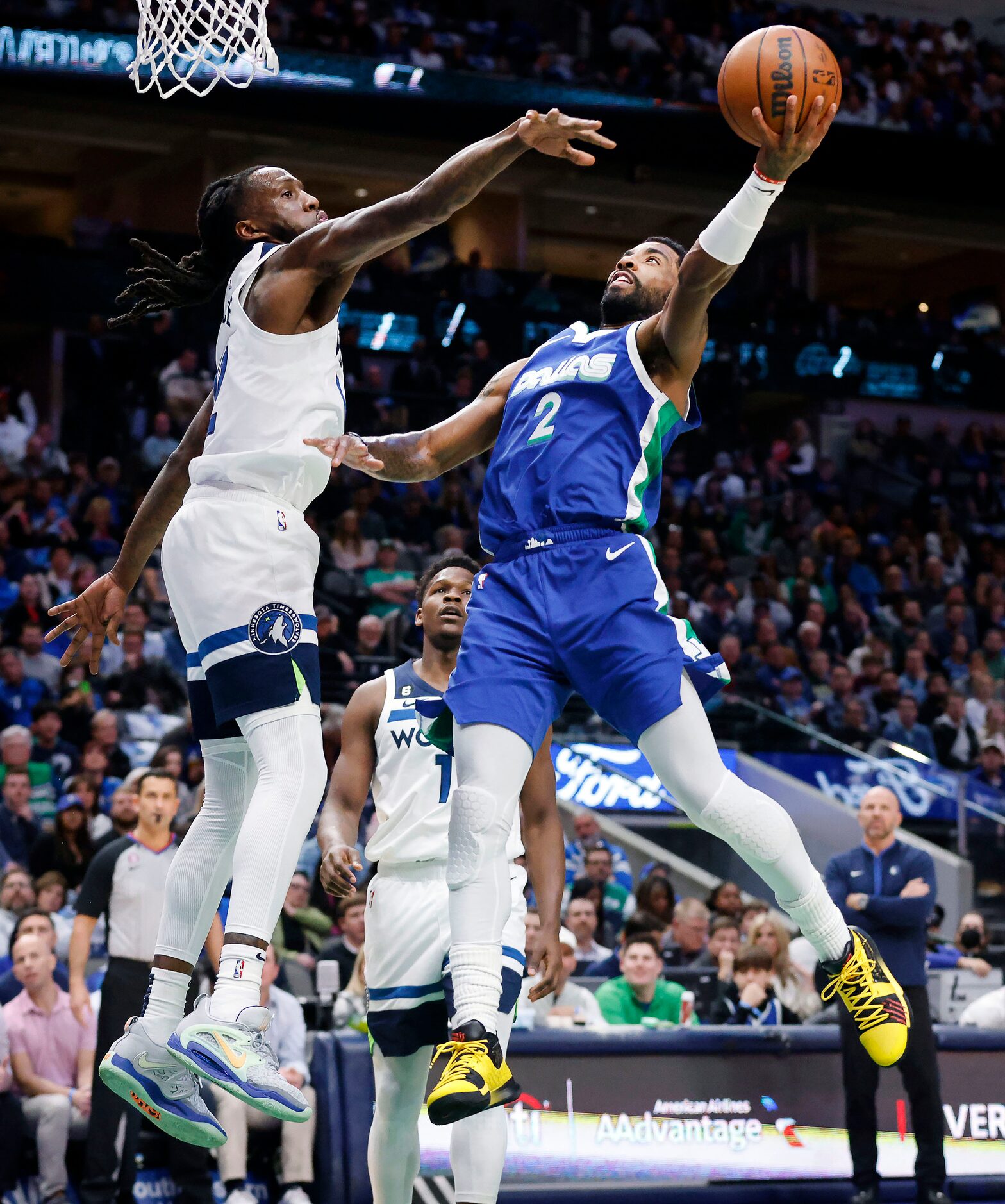 Dallas Mavericks guard Kyrie Irving (2) puts up a shot over Minnesota Timberwolves forward...