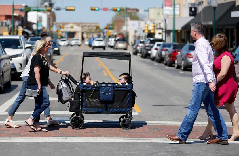 People watch as Celia Moorman of Frisco walks with Jenny Marr as she pushes her quadruplets...