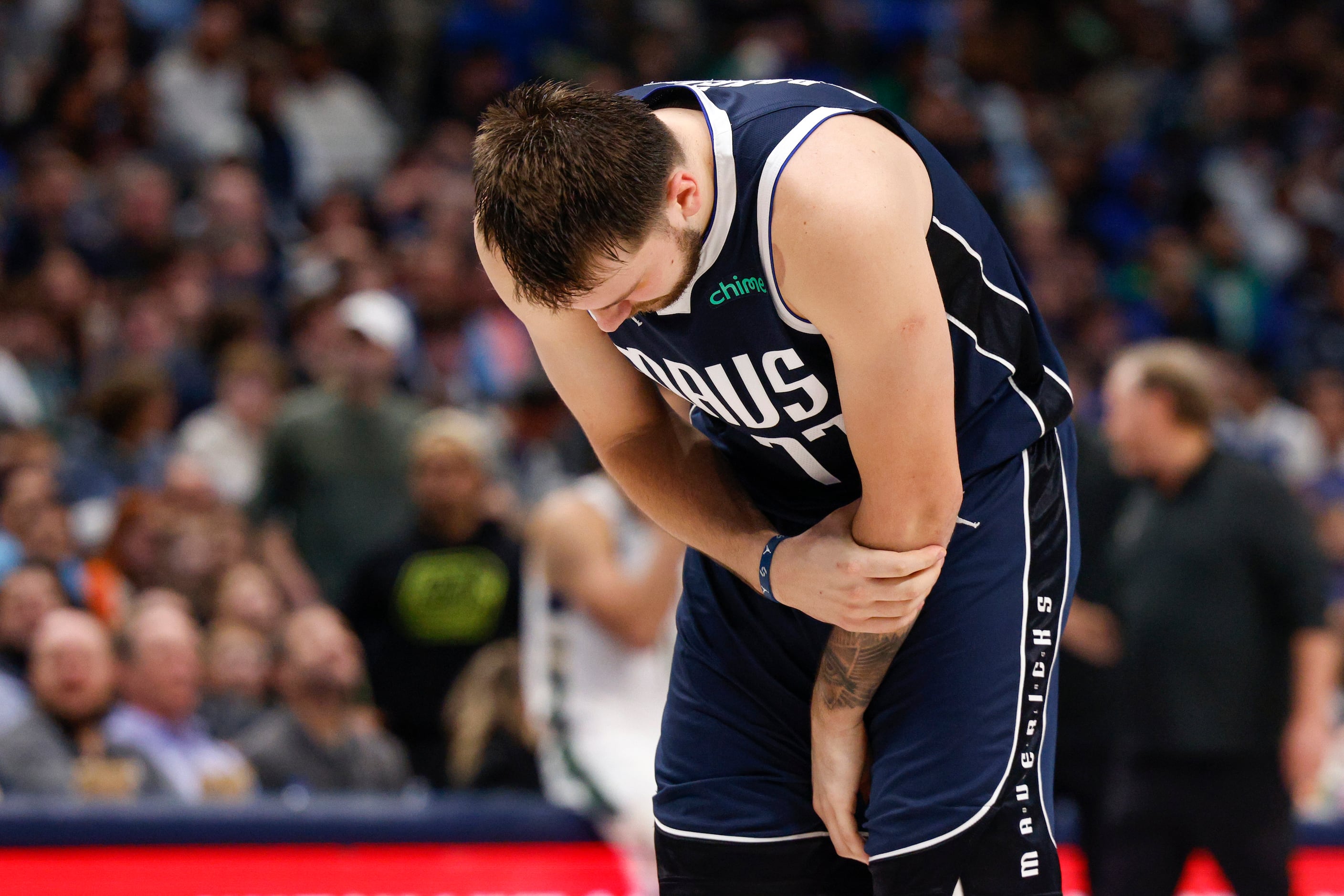 Dallas Mavericks guard Luka Doncic (77) grabs his arm after being fouled during the second...