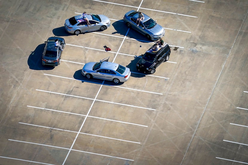 Young people gathered in the parking lot of McKinney High School on March 24, 2020. After...