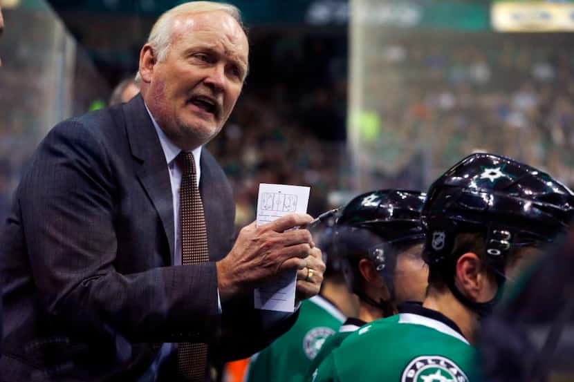 Dallas Stars coach Lindy Ruff talks to his team as they play the Winnipeg Jets during the...