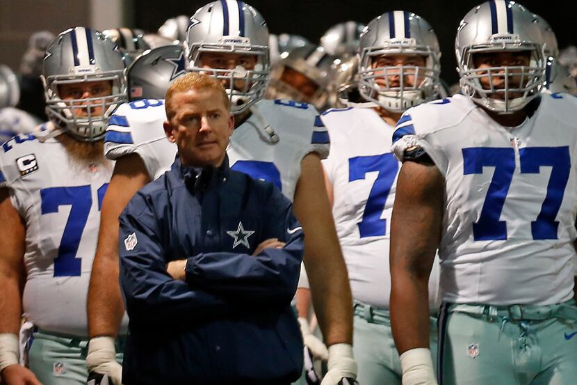 Dallas Cowboys head coach Jason Garrett and his players wait to take the field against New...