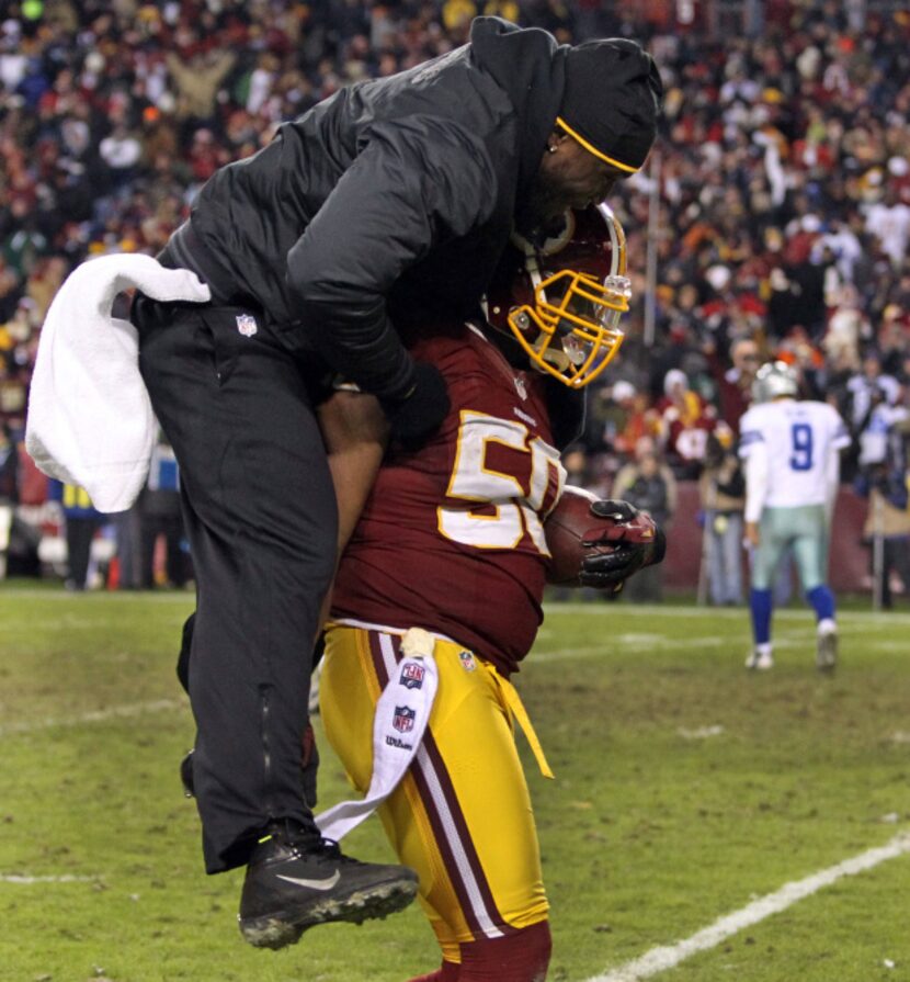 Injured Redskins linebacker Brian Orakpo (in black) congratulates Washington Redskins...