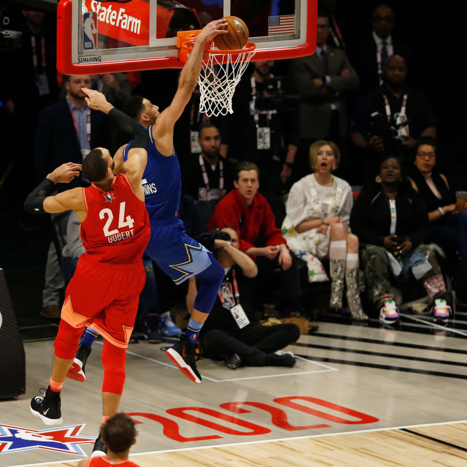 Team LeBron's Ben Simmons (2) dunks in front of Team Giannis' Rudy Gobert (24) during the...