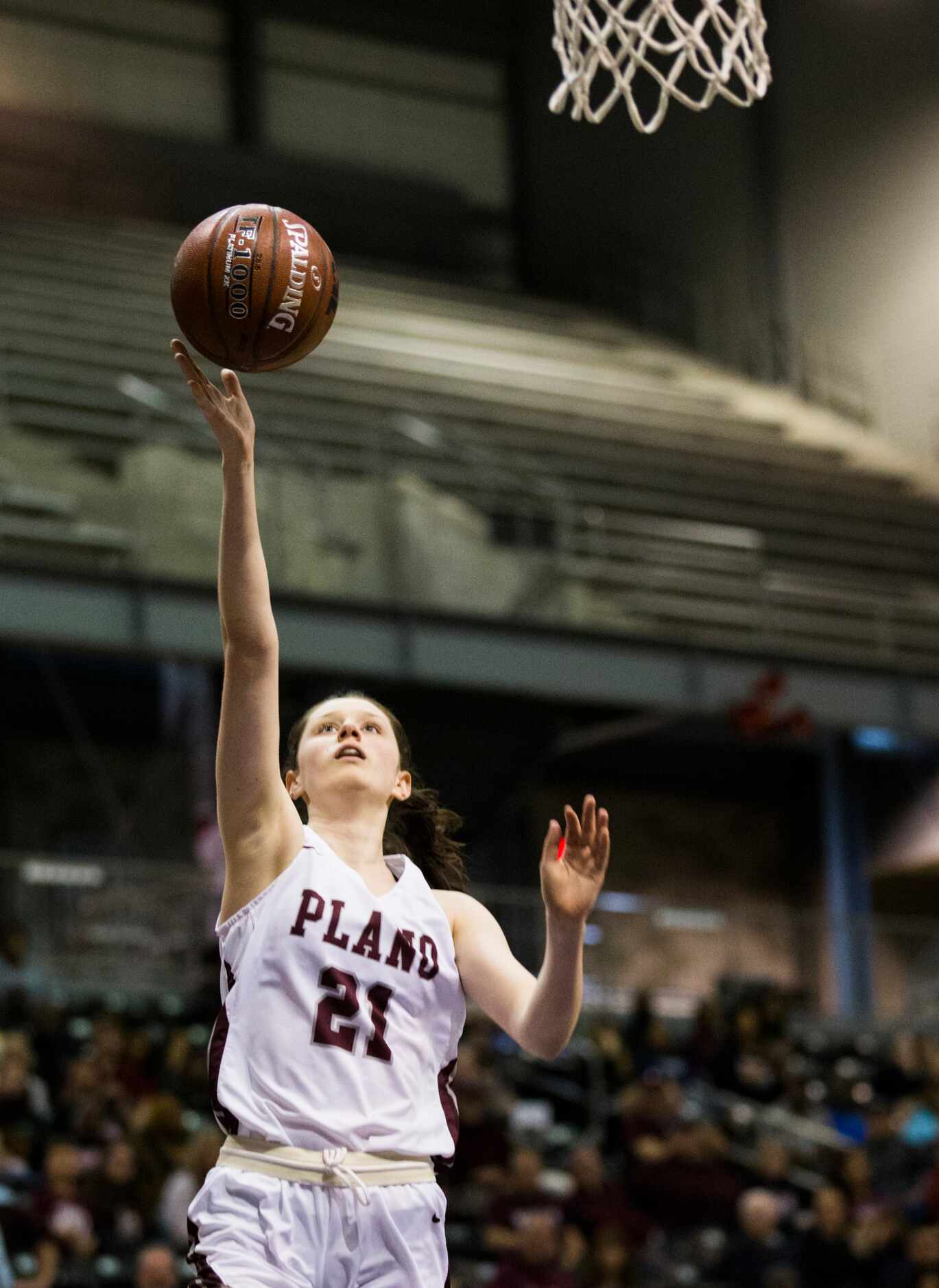 Plano forward Josie Bruder (21) takes a shot during the second quarter of a UIL 6A Region II...