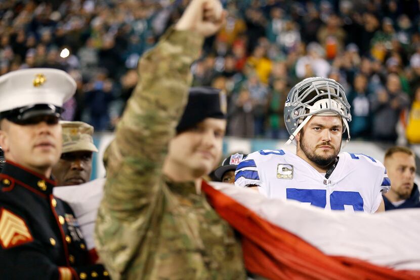 Dallas Cowboys offensive guard Zack Martin (70) watches as U.S. serviceman cheer on th...