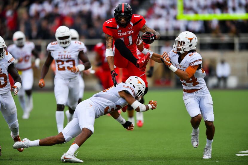 LUBBOCK, TX - NOVEMBER 05: Derrick Willies #11 of the Texas Tech Red Raiders tries to leap...