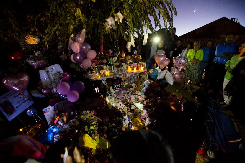 People gather at a memorial for3-year-old Sherin Mathews on Sunday.