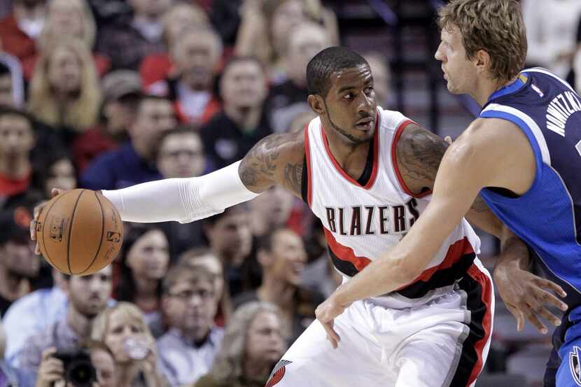 Portland Trail Blazers forward LaMarcus Aldridge, left, works the ball in against Dallas...