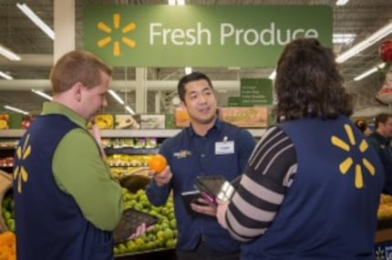  Wal-Mart training manager Steven Yu leads a team of 14 trainers at a store in Carrollton....