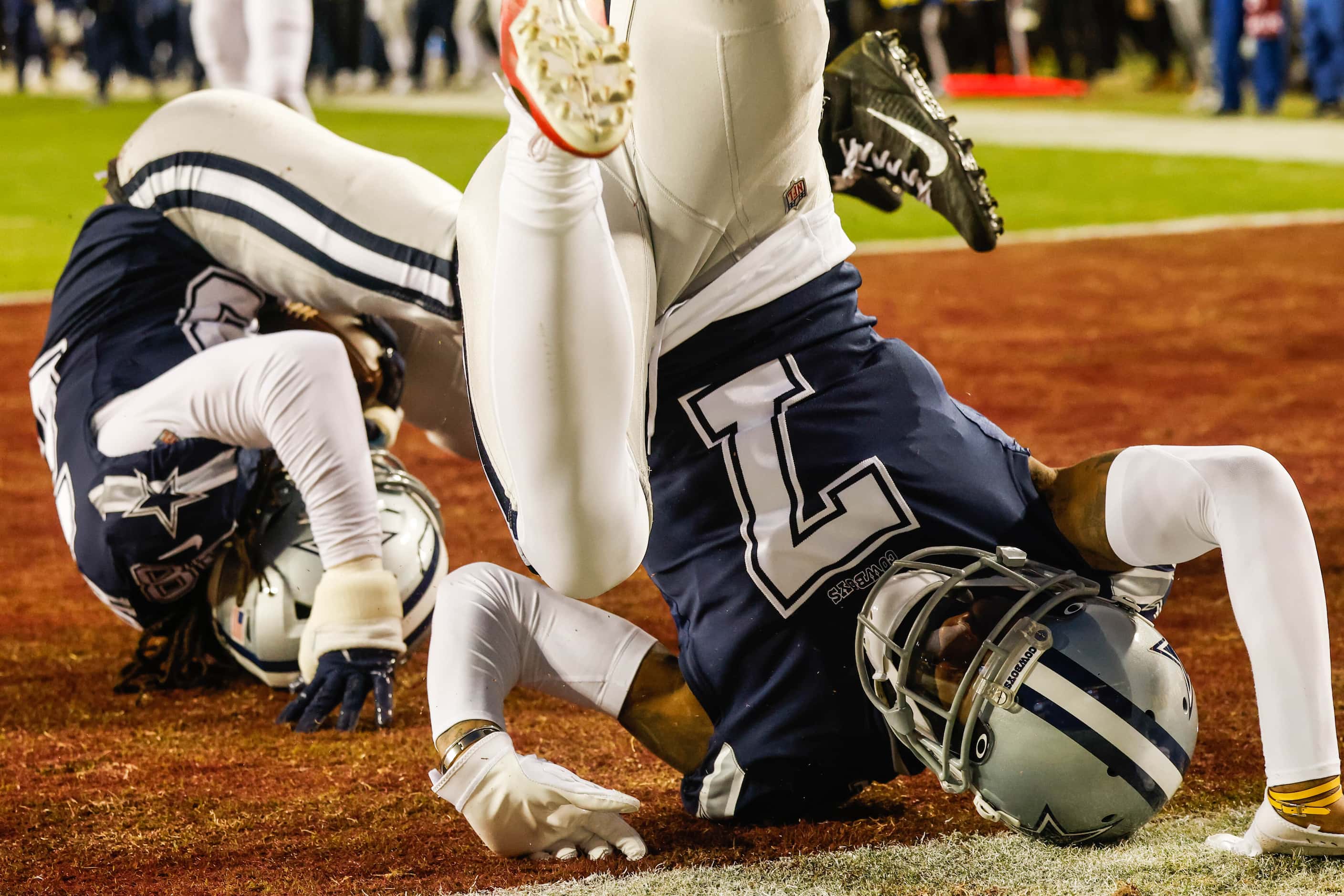 Dallas Cowboys cornerback Trevon Diggs (7) rolls on the ground after Dallas Cowboys safety...