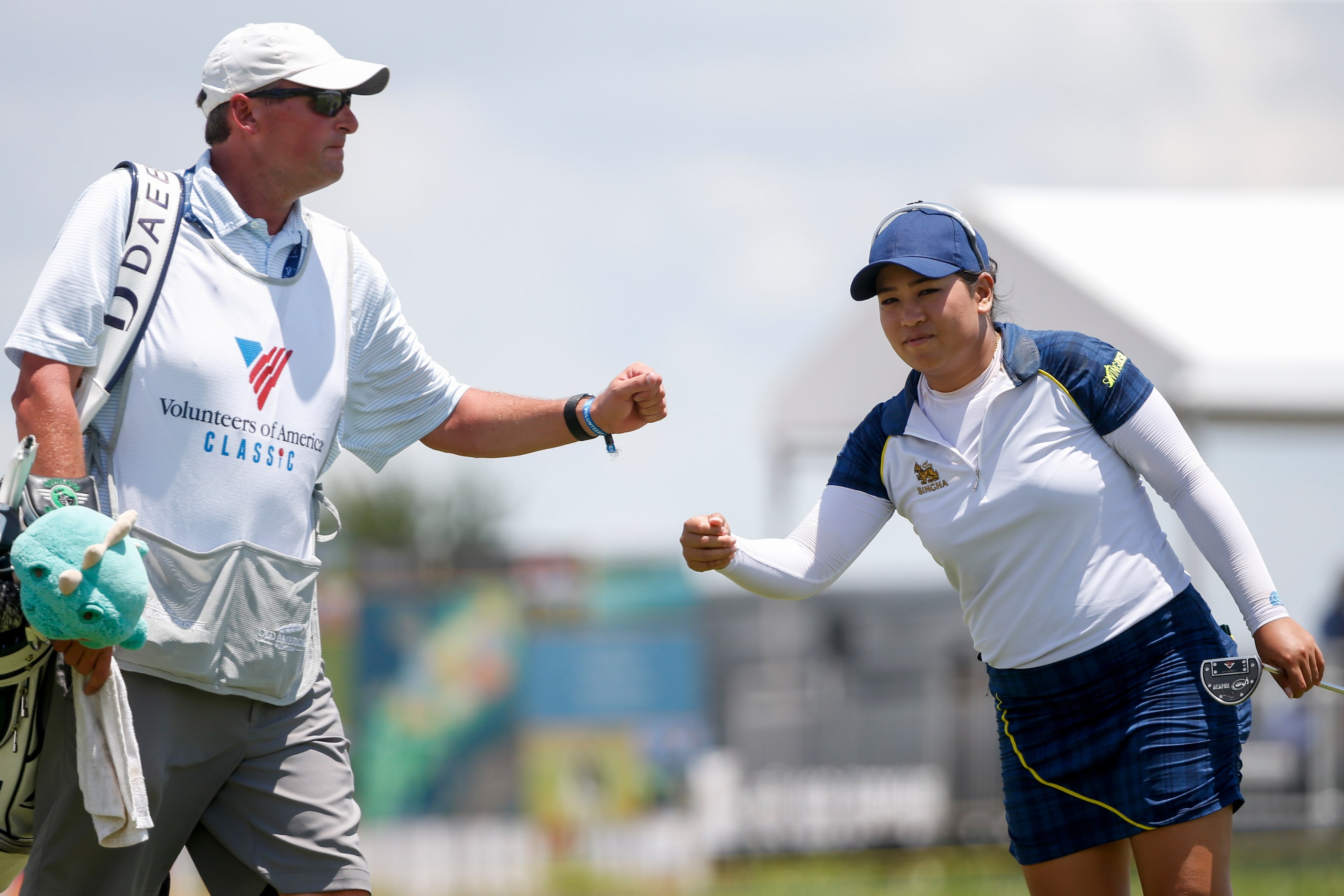 Professional golfer Jasmine Suwannapura fist bumps caddie Scott Leonard after a birdie on...