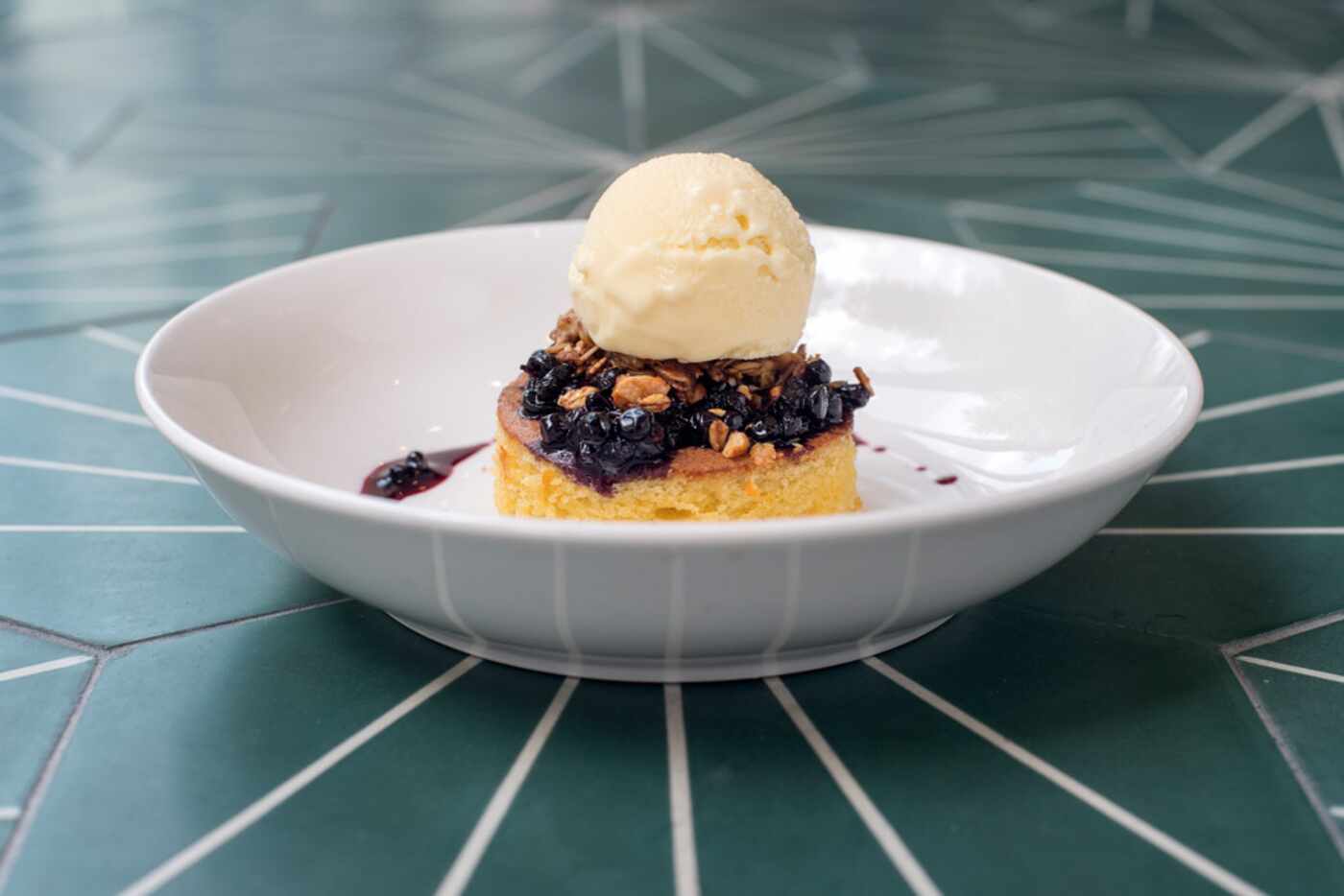 A dessert features almond cake with huckleberry compote and lemon thyme ice cream at Sachet,...