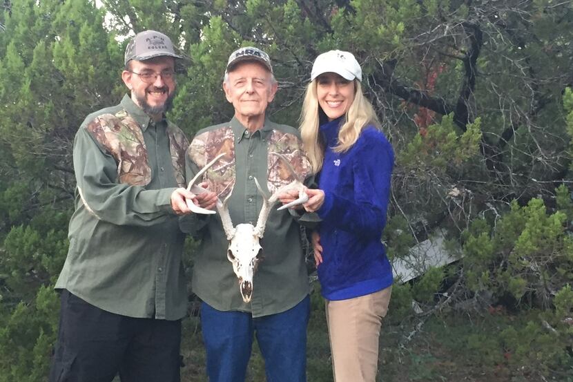 John T. Baker, son Johnny and his daughter, Shawn. with the skull of a buck they found hung...