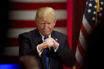 Republican presidential candidate Donald Trump poses with a ring given to him by a group of...