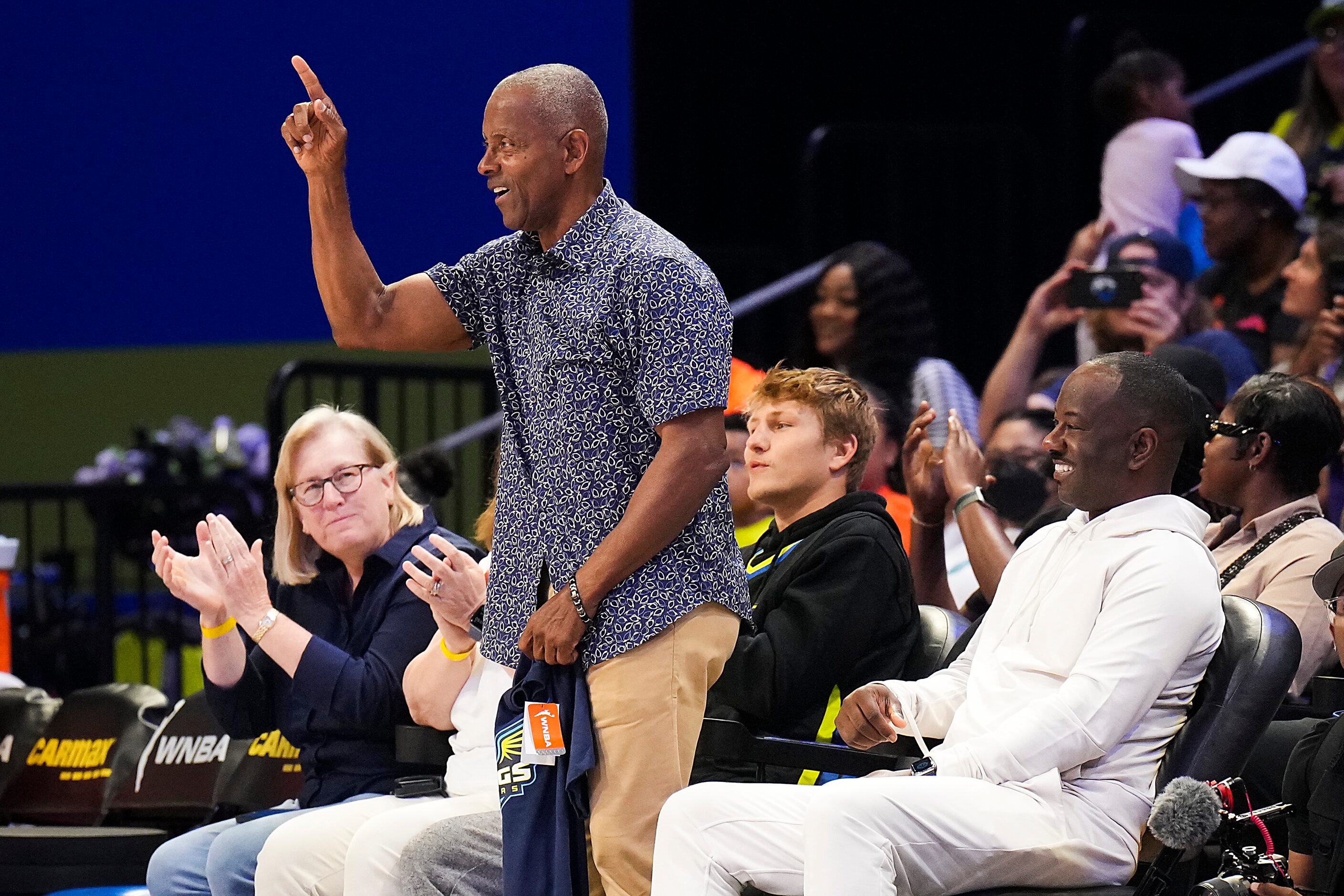 Former Dallas Cowboys great Tony Dorsett is recognized during the first half of a WNBA...