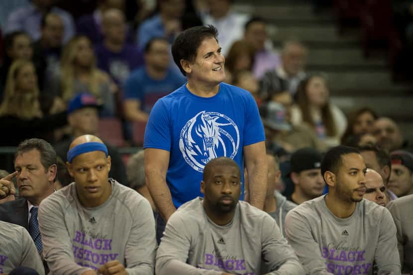 Dallas Mavericks owner Mark Cuban watches from behind the Mavericks's bench before action...
