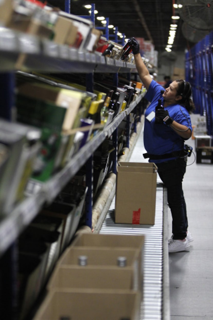 Rafaela Williamson loads boxes of liquor at Glazer's distributor center, one of the largest...