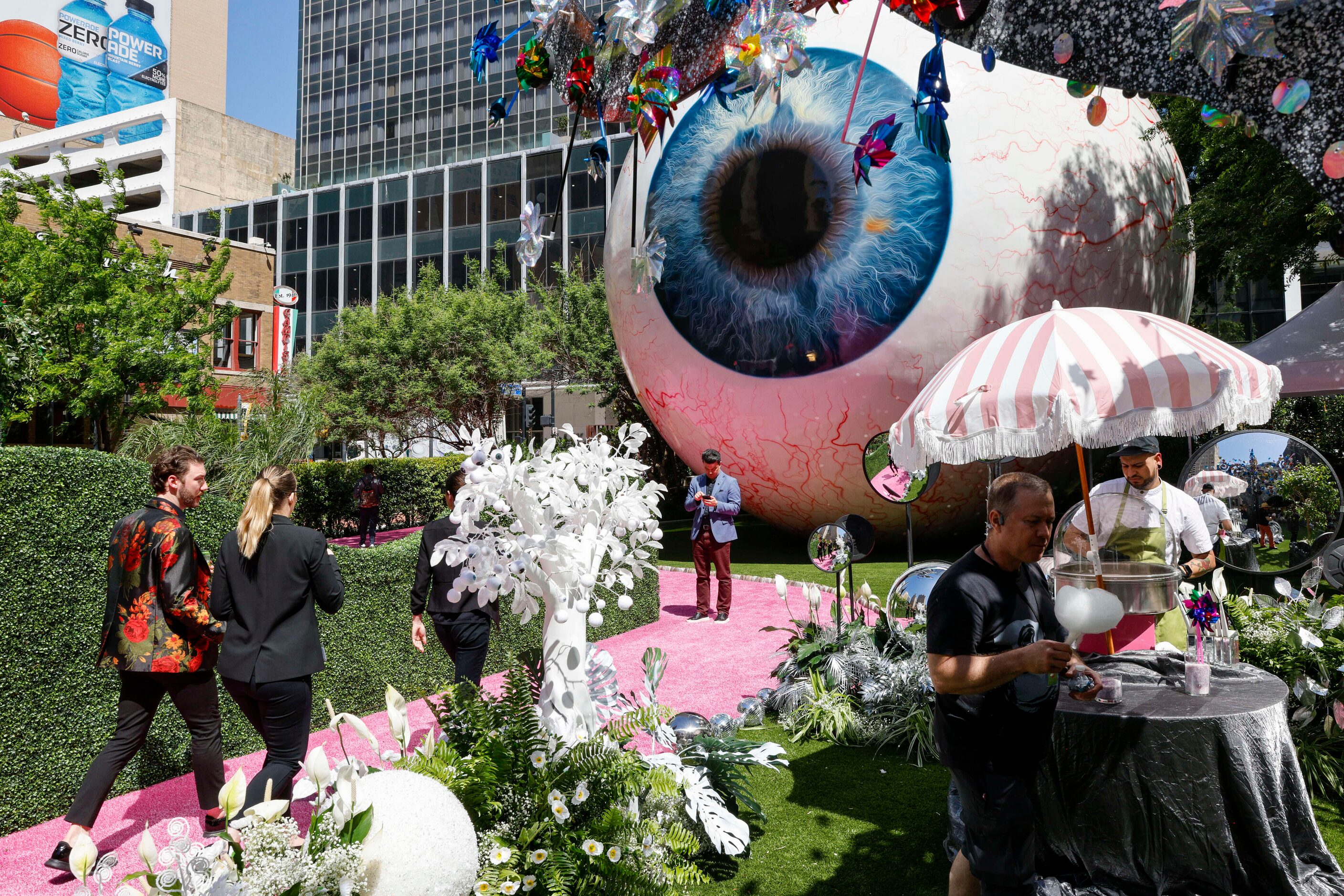 People take photos and have cotton candy at the Eyeboretum on Friday.