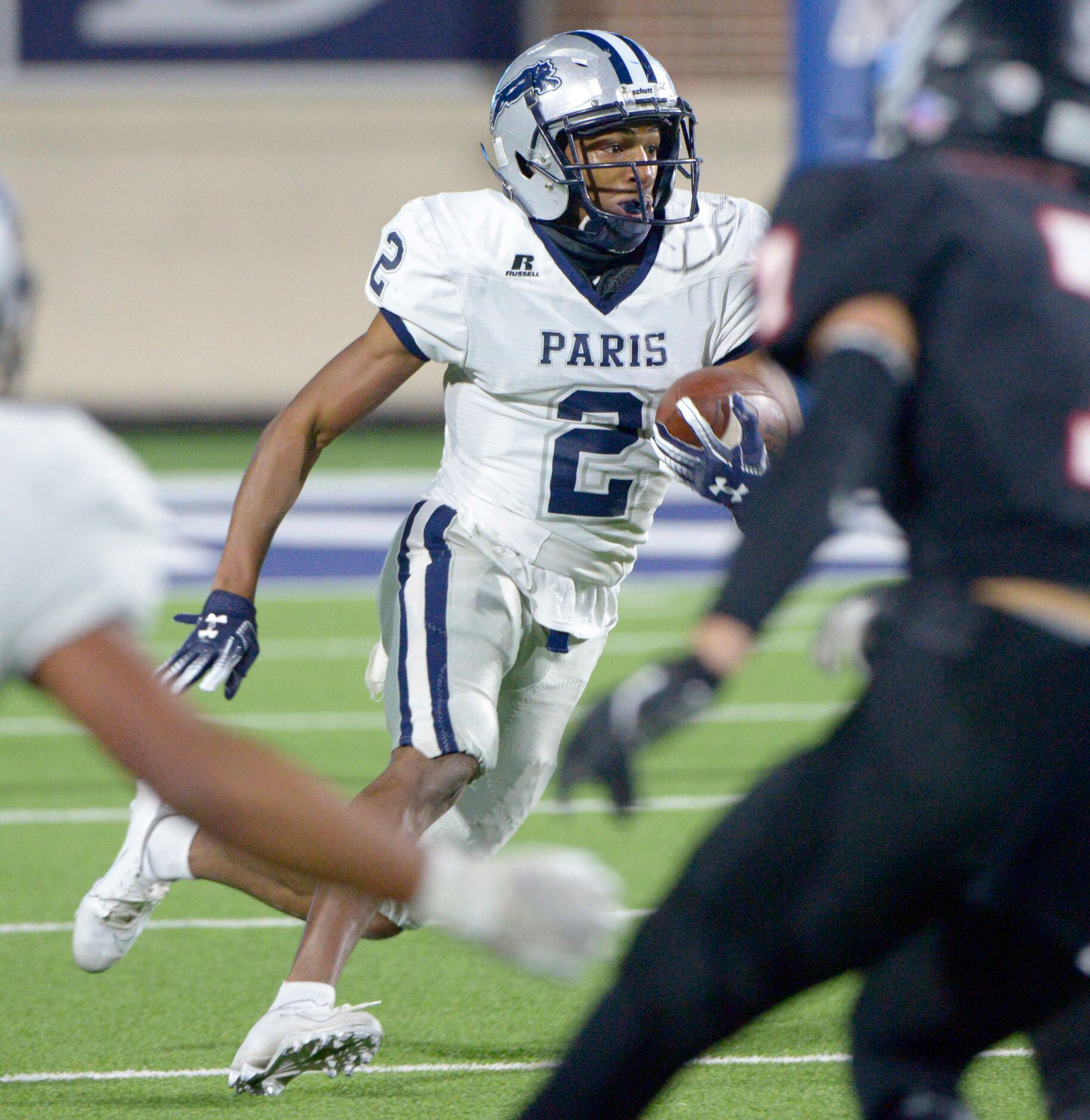 Paris’ KD Washington (2) looks for running room in the first half during a Class 4A Division...