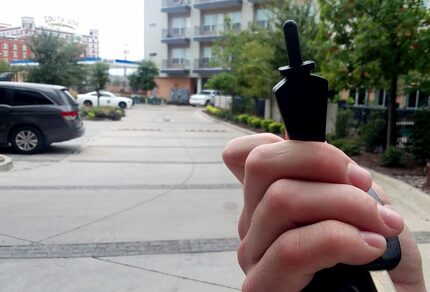 A resident holds up an electronic key used to open an apartment door at the South Side Flats...