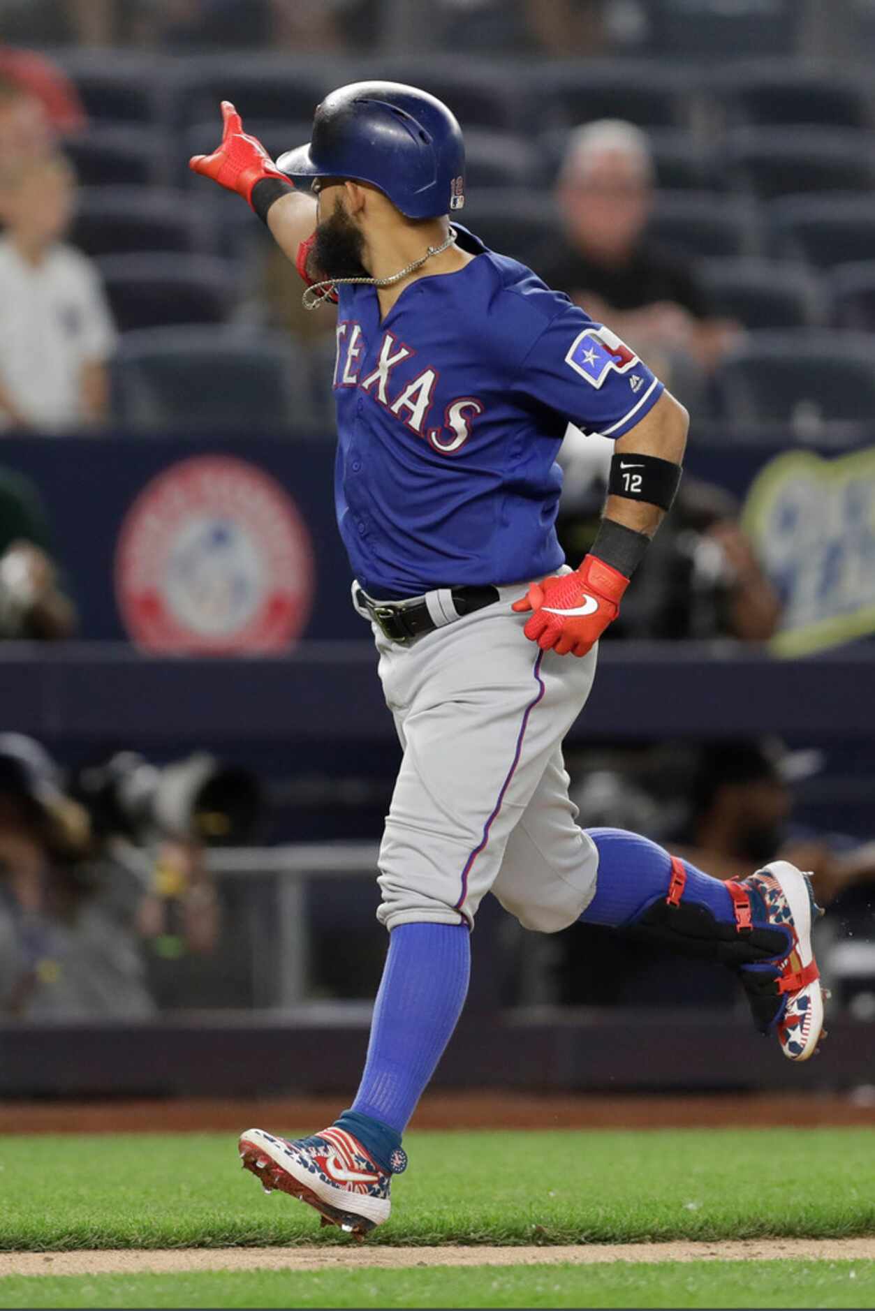 Texas Rangers' Rougned Odor gestures to the crowd after hitting a solo home run off New York...