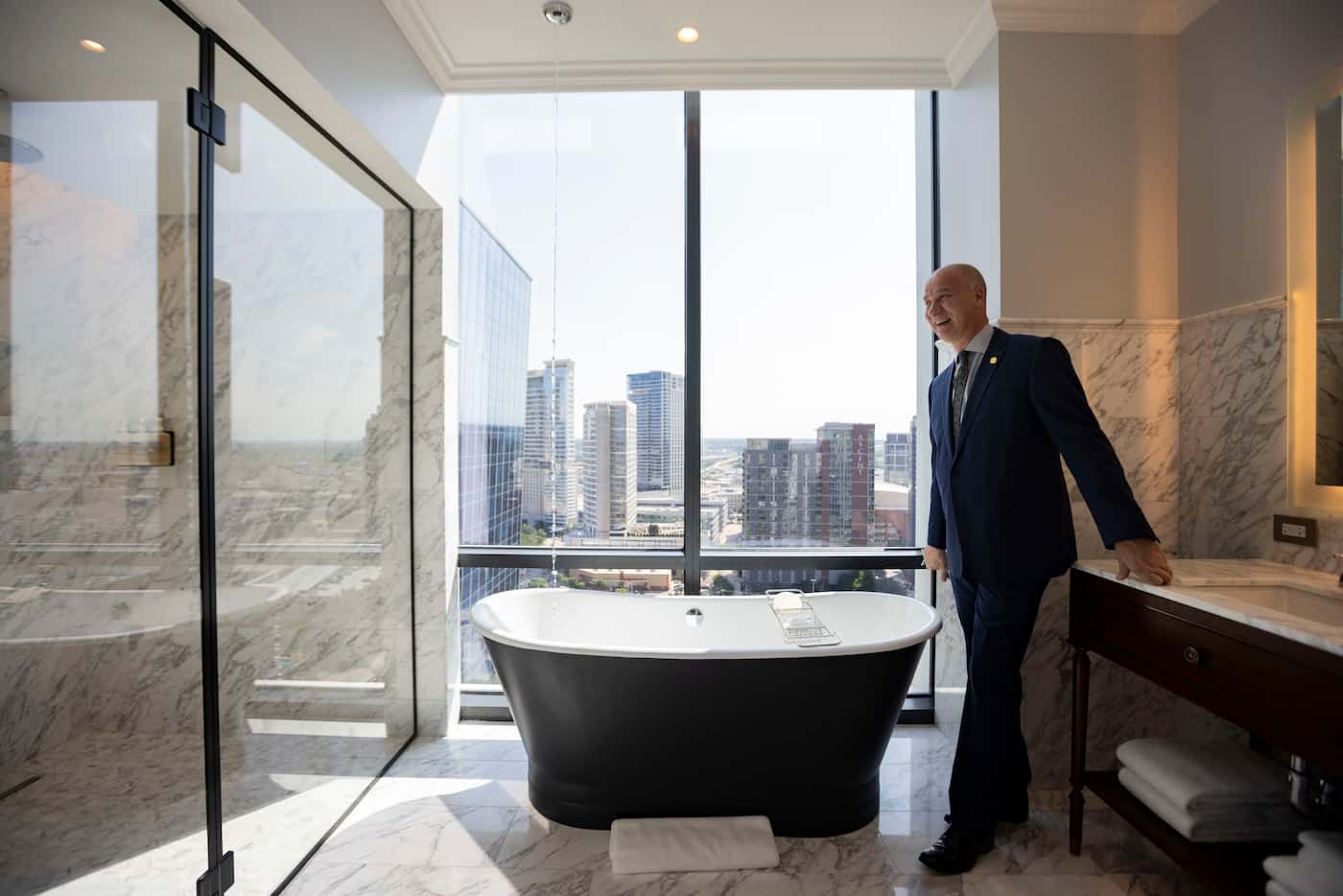 Julian Payne, general manager of Hôtel Swexan, shows the bathtub in room 1702 that’s filled...