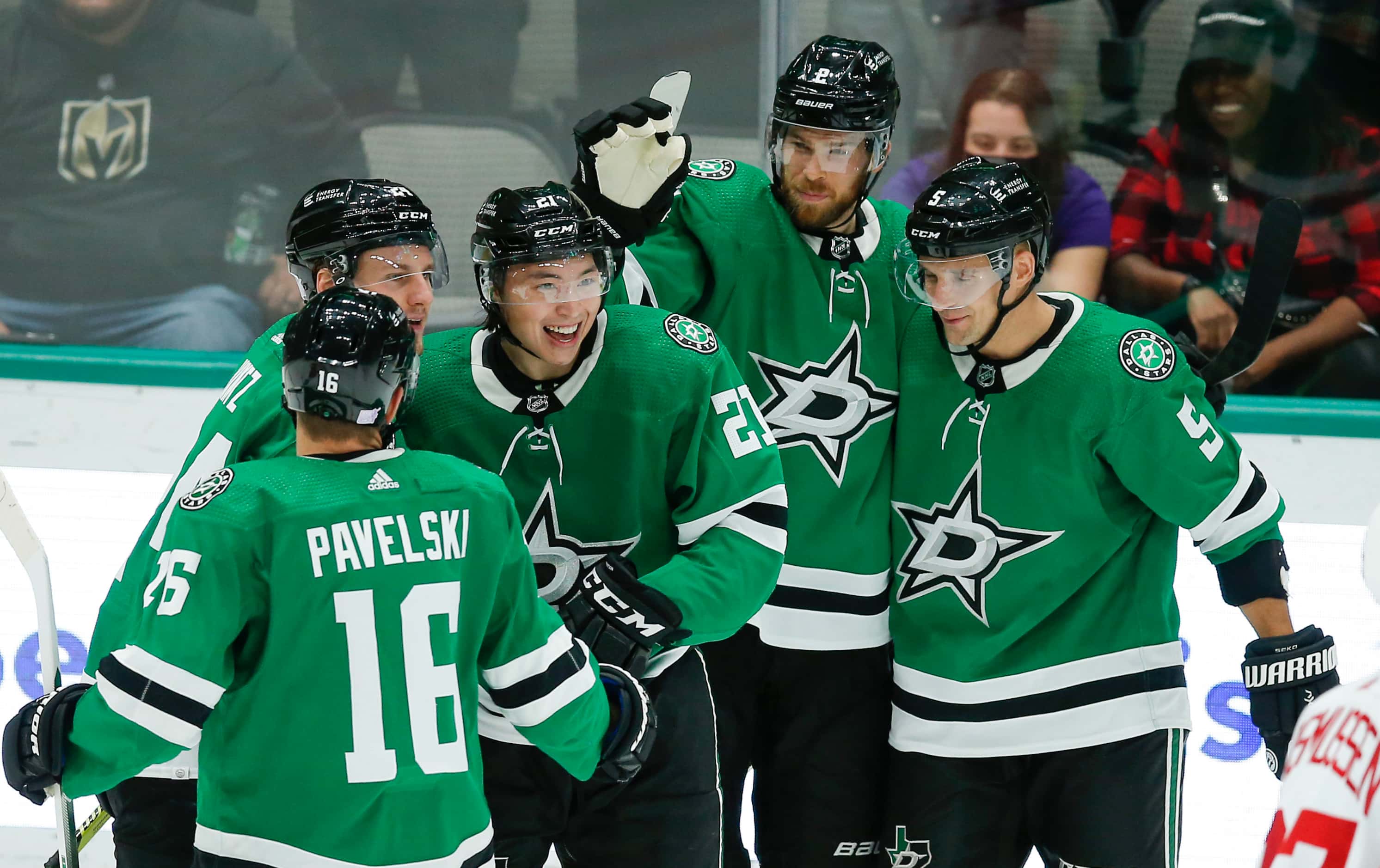 Dallas Stars forward Jason Robertson, third from left, is congratulated by teammates after...
