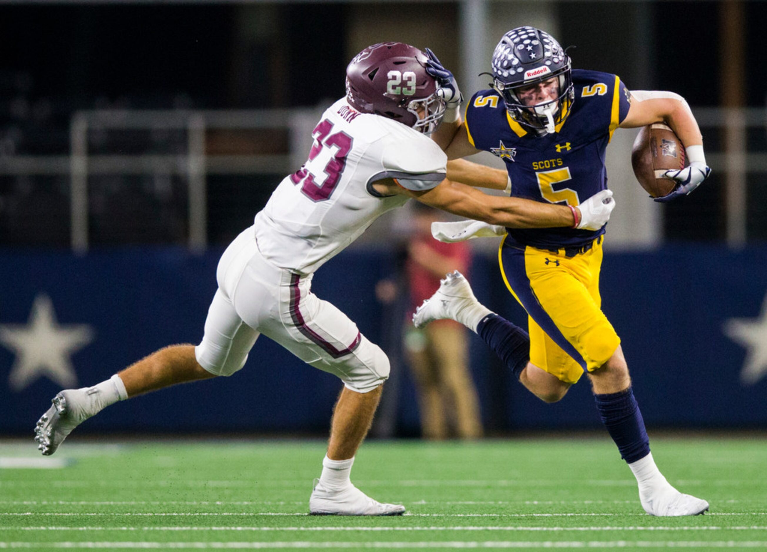 Highland Park receiver Case Savage (5) pushes away Magnolia defensive back Blaine Dunn (23)...