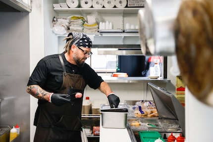 Dave Culwell prepares a burger at Craft and Growler in Dallas. It's the single place to get...