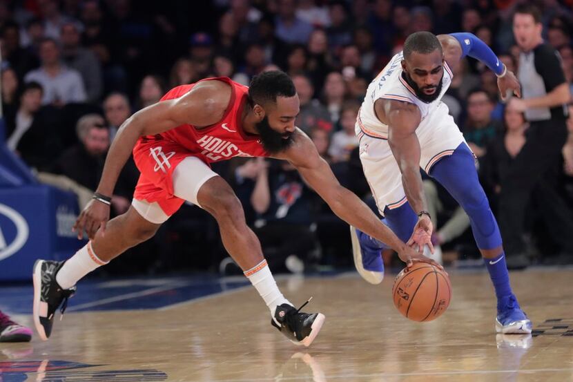 Houston Rockets' James Harden, left, and New York Knicks' Tim Hardaway Jr. reach for the...