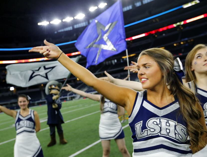 Frisco Lone Star cheerleaders listen to the school song before facing Lancaster in the 5A...