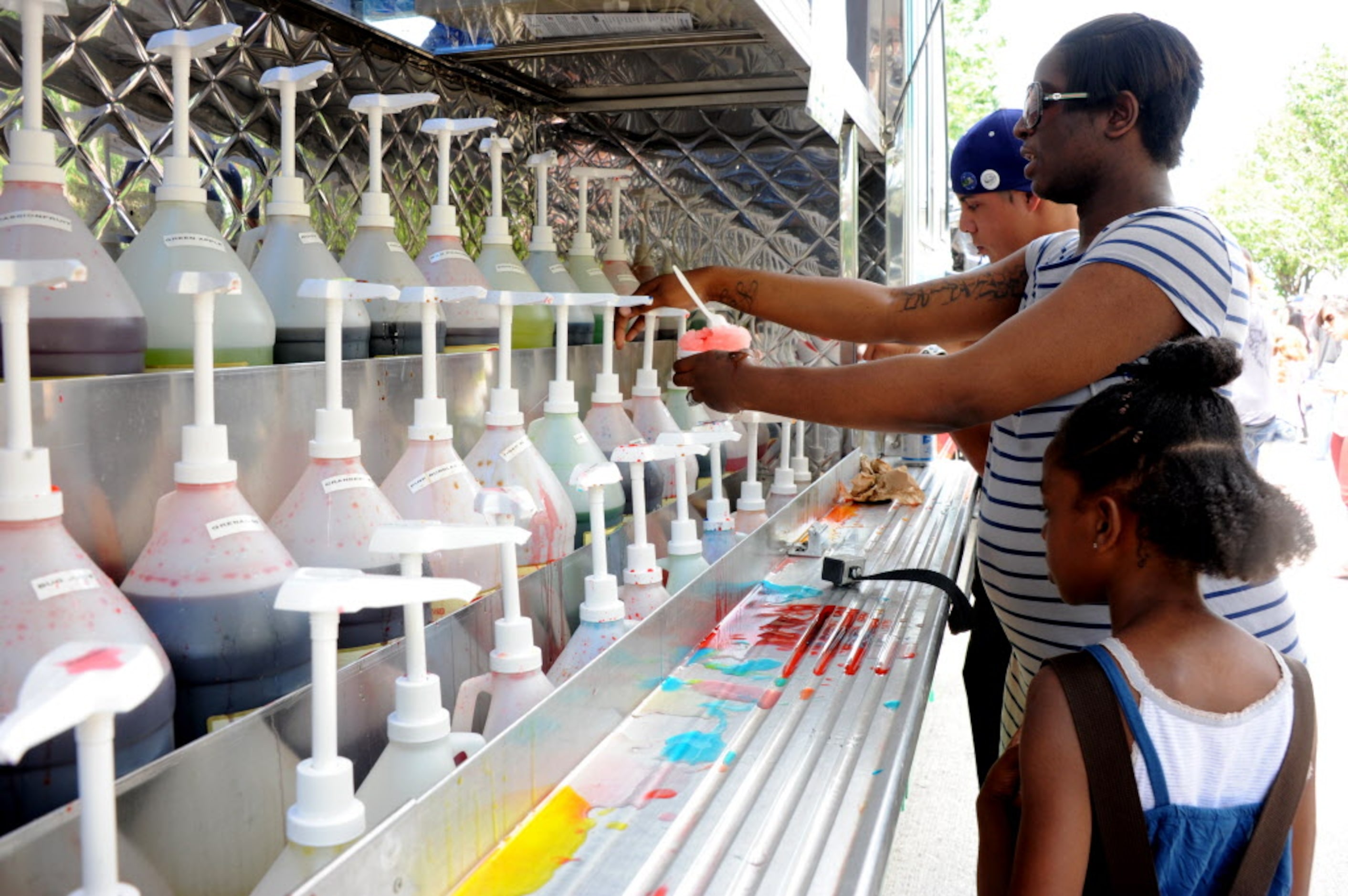 Keneshia and daughter Keimora, 7, from Lancaster make their own snow cones at Mr. Snowie...