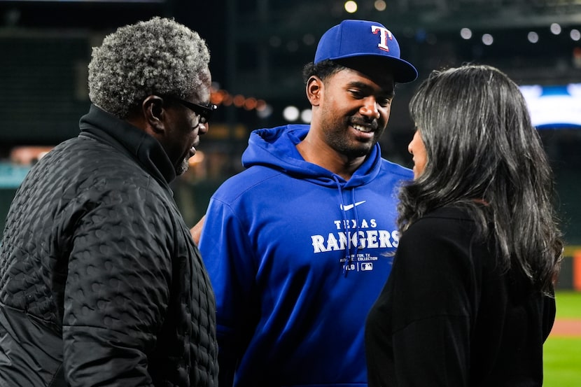 Texas Rangers starting pitcher Kumar Rocker, center, greets his father and Tennessee Titans...