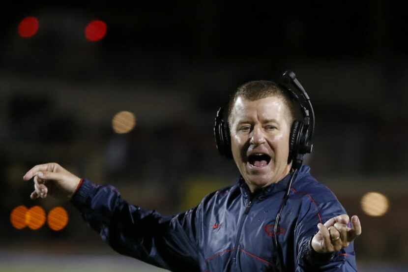 Allen's Head Coach Tom Westerberg directs his team against Plano East during the first half...