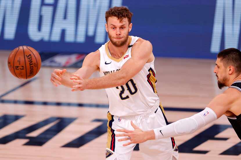 Nicolo Melli, left, of the New Orleans Pelicans passes the ball during the first quarter of...